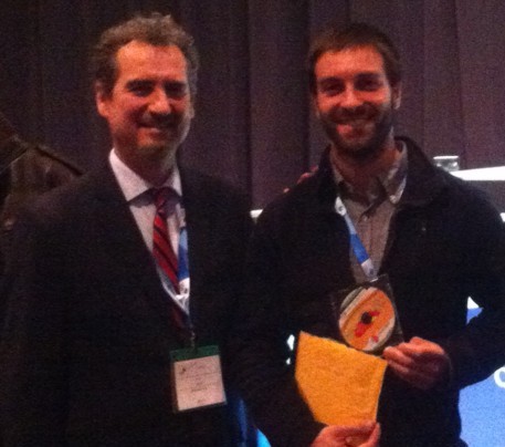 Presentation of book award to David Banville, Masters student at Laval University (R) by Jean Legault (Dir), Geotech.